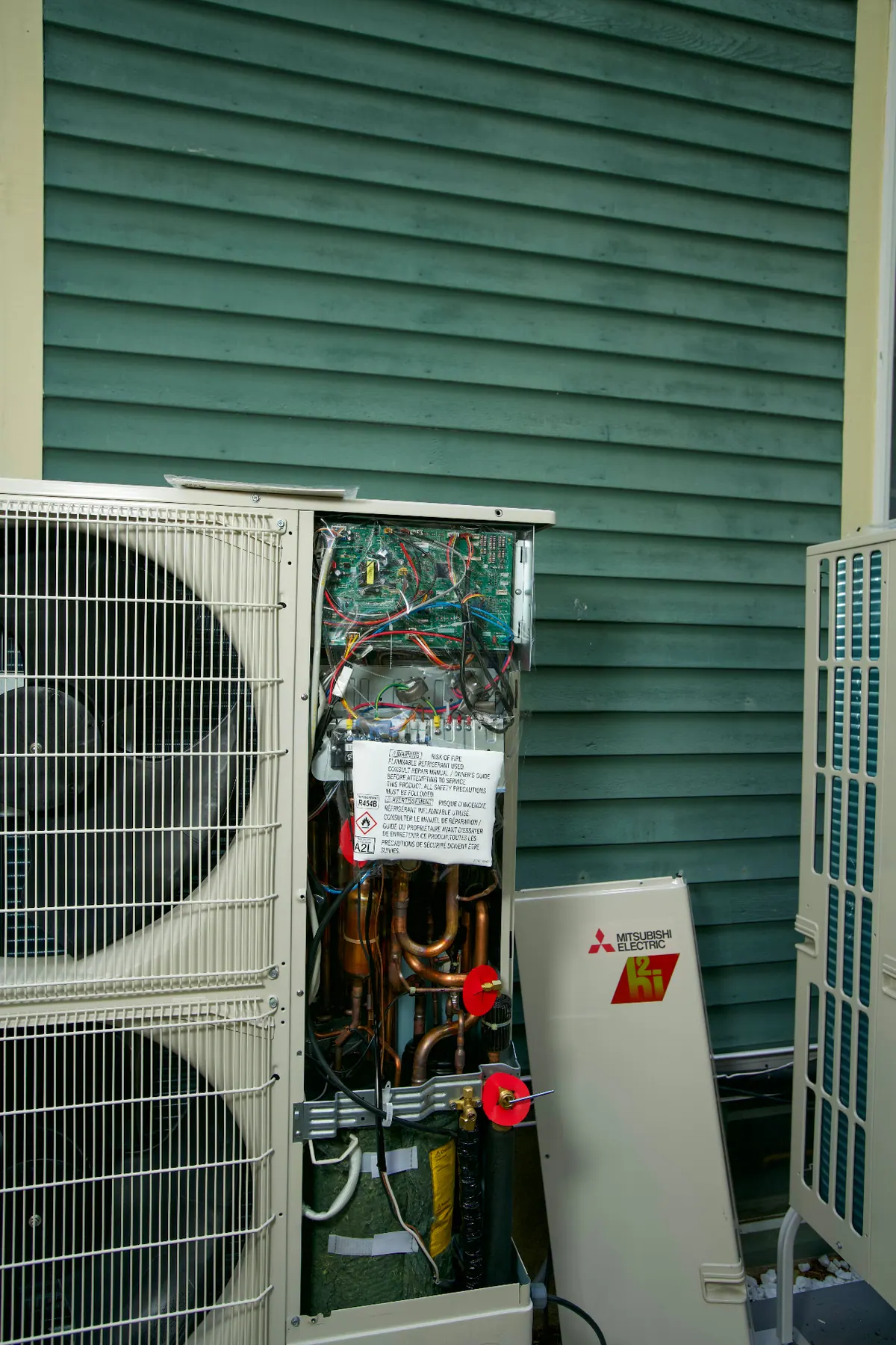 Open Mitsubishi condenser being repaired during AC service