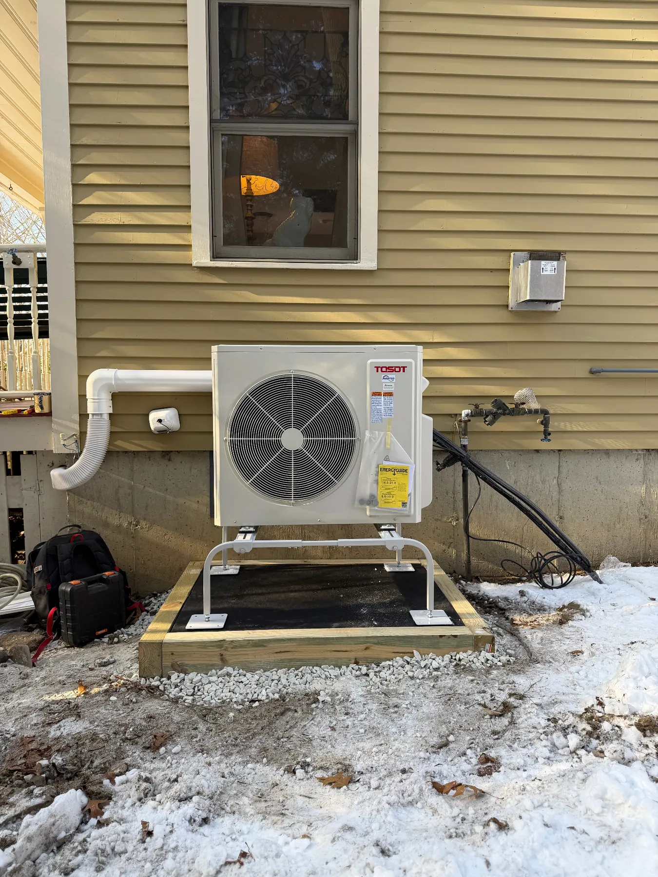 Finished Tosot outdoor condenser on a stand at a Massachusetts home