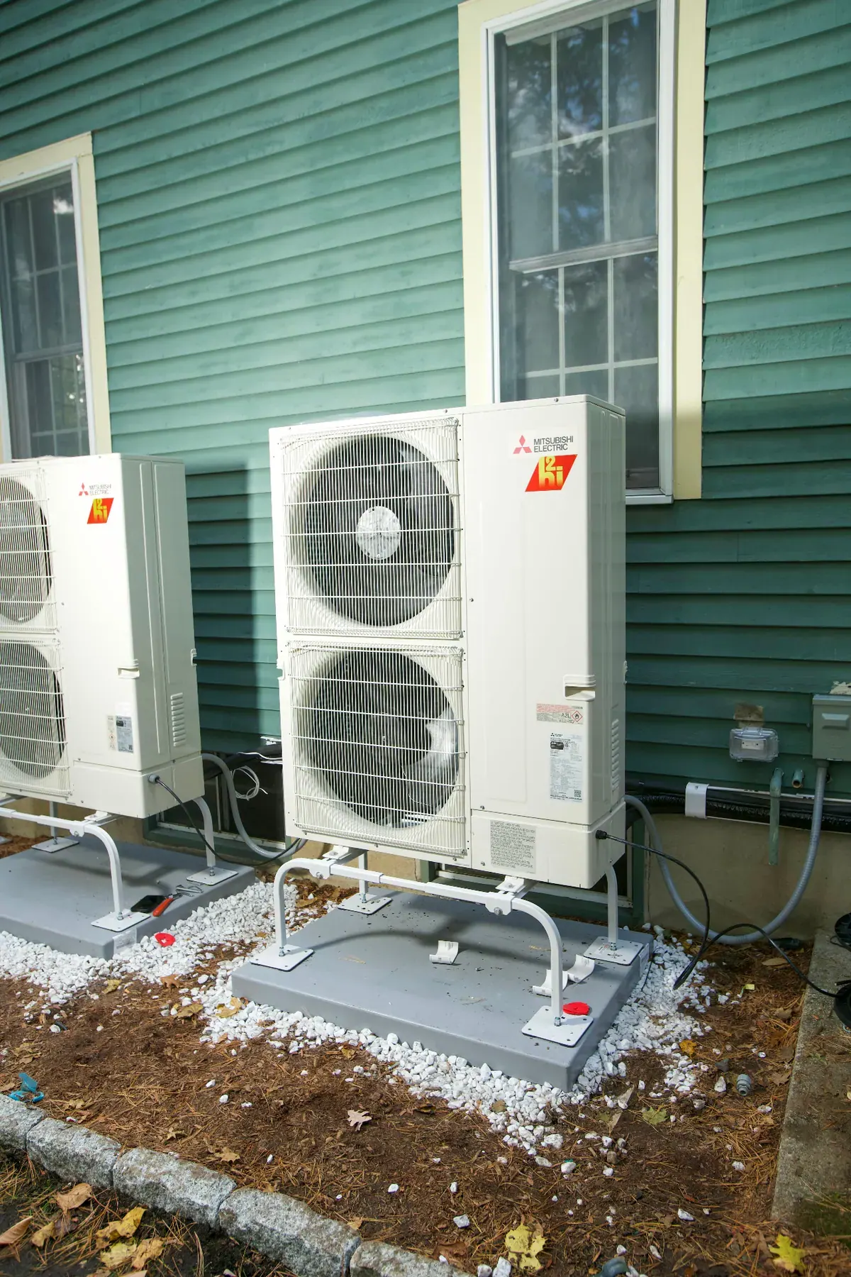 Mitsubishi Electric heat pump condensers installed beside a home