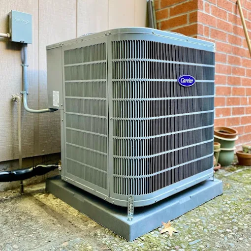 Carrier outdoor condenser unit installed beside a home
